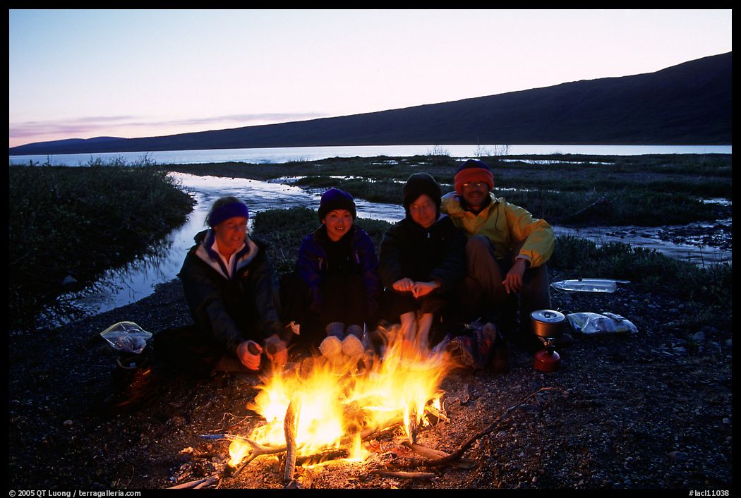 Warming toes on campfire next to Turquoise Lake. Lake Clark National Park, Alaska