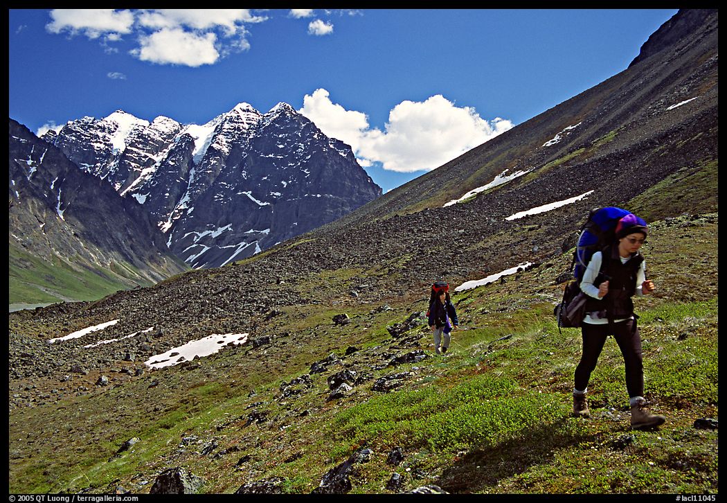 Backpackers walking on a slope. Lake Clark National Park, Alaska