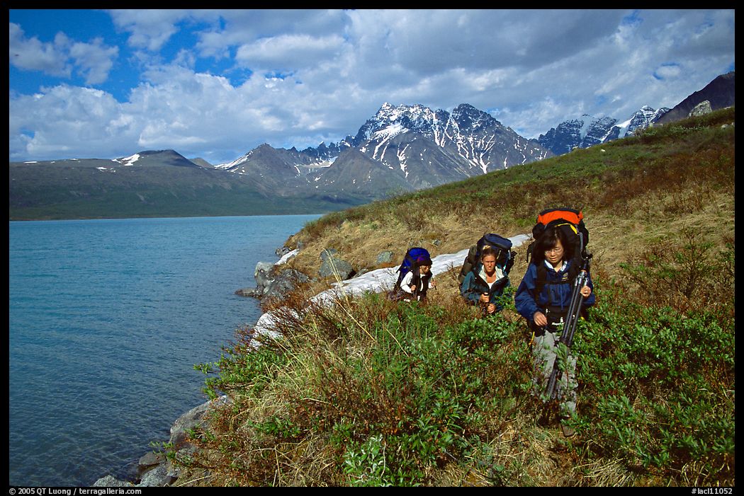 Backpackers travelling cross-country on the shore of Turquoise Lake. Lake Clark National Park, Alaska