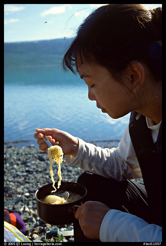 Backpacker eating noodles from a camp pot. Lake Clark National Park, Alaska