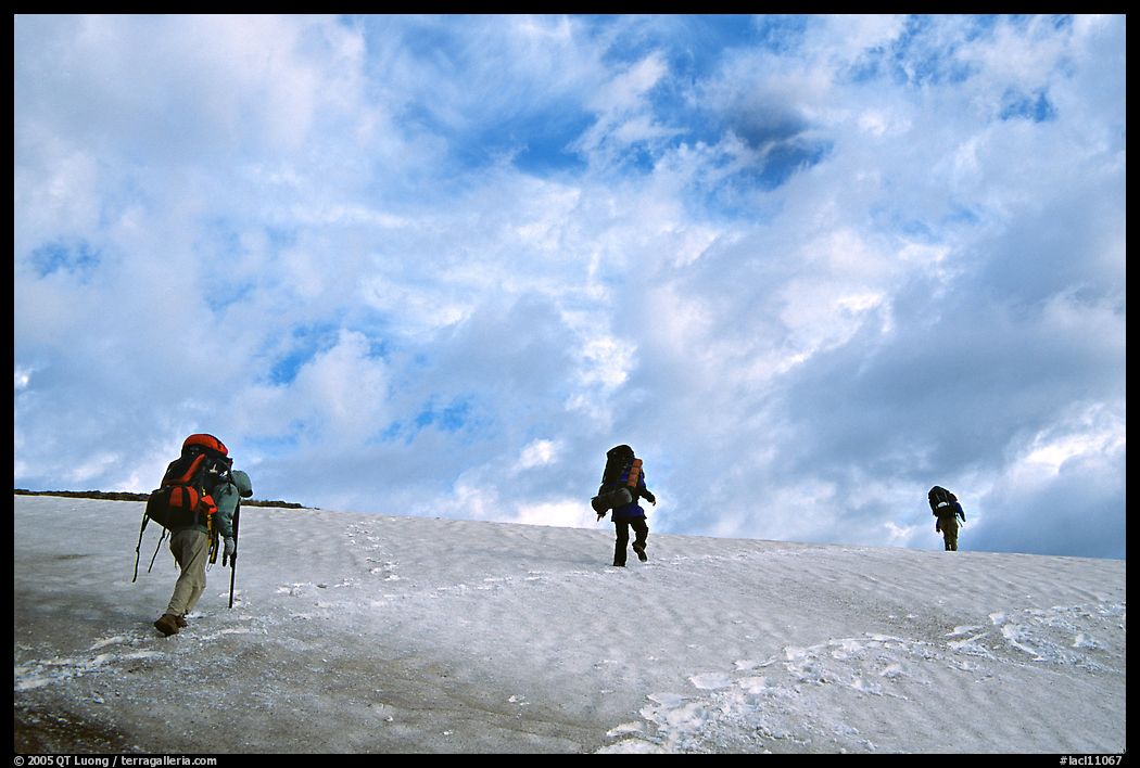 Backpackers crossing a neve. Lake Clark National Park, Alaska