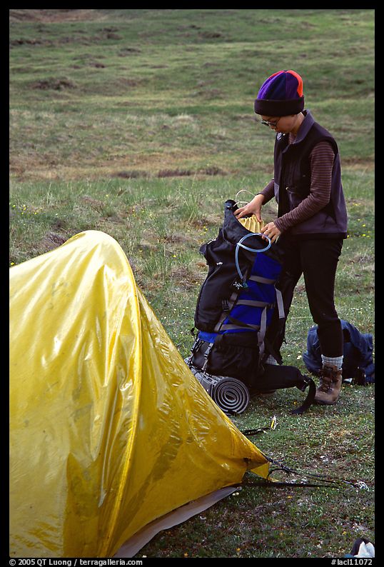 Backpacker unpacking backpack into the tent. Lake Clark National Park, Alaska
