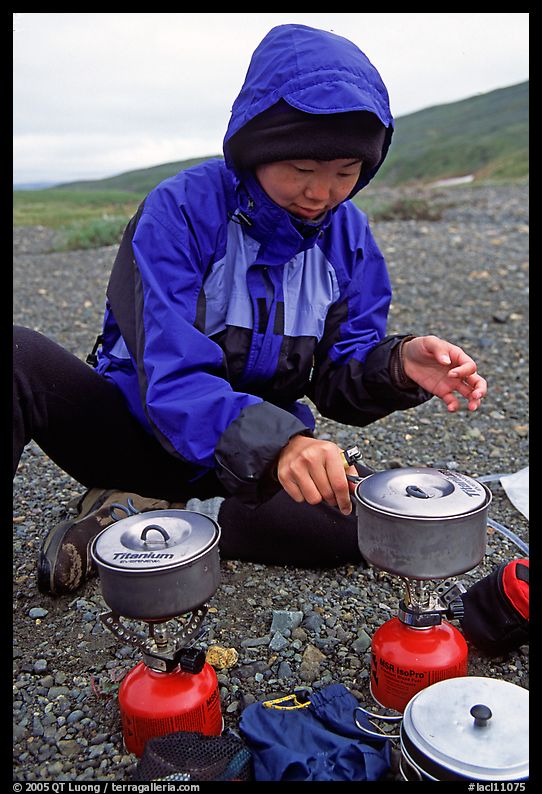 Backpacker cooks meal on gas campstove. Lake Clark National Park, Alaska