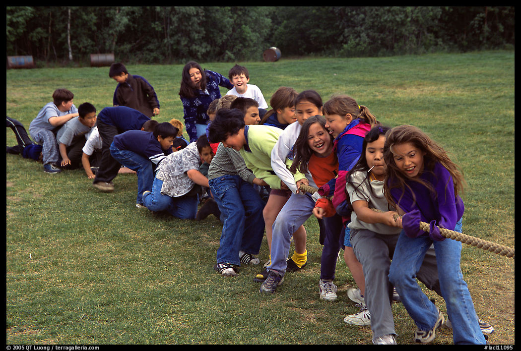 Children playing tug-of-war with a rope. Lake Clark National Park, Alaska