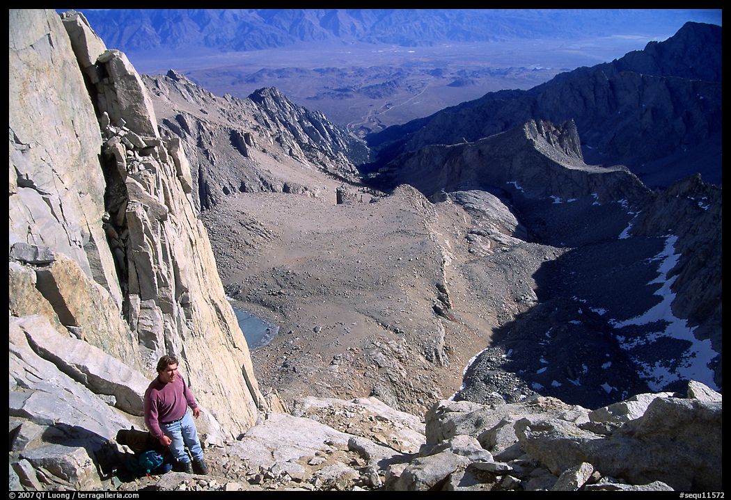 Man pausing on steep terrain in the East face of Mt Whitney. Sequoia National Park, California