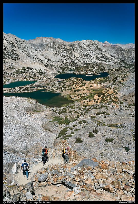 Hikers on trail above Saddlebag Lakes, John Muir Wilderness. Kings Canyon National Park, California