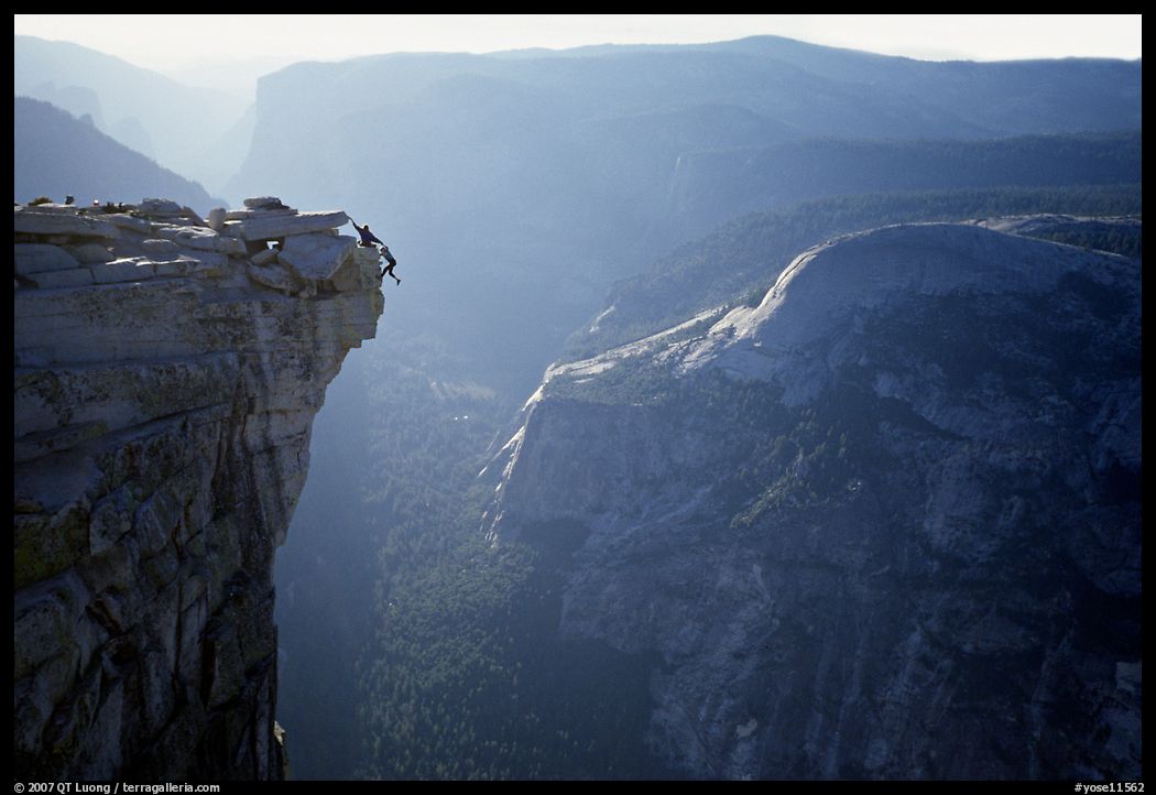 Hanging dramatically from the Jumping Board, Half-Dome. Yosemite National Park, California