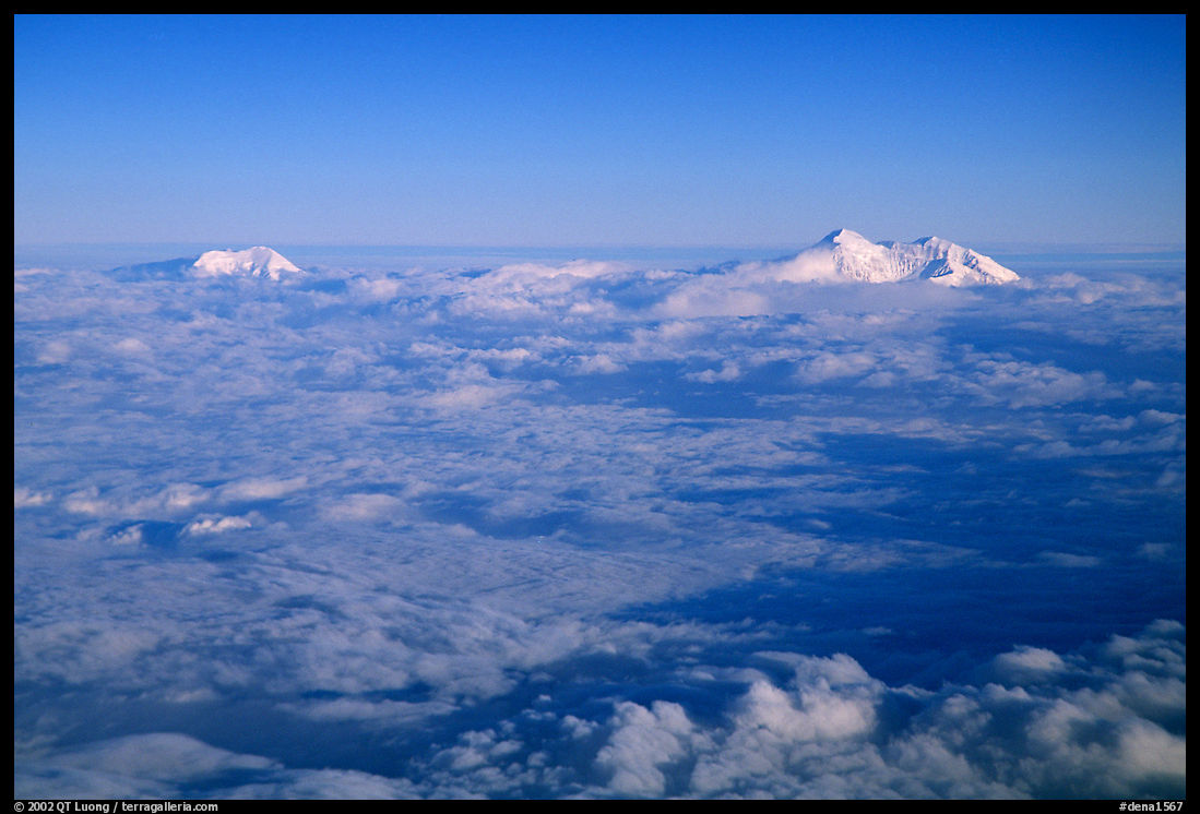 Summit of Mt Foraker and Mt Mc Kinley emerging from  clouds. Denali  National Park, Alaska, USA.