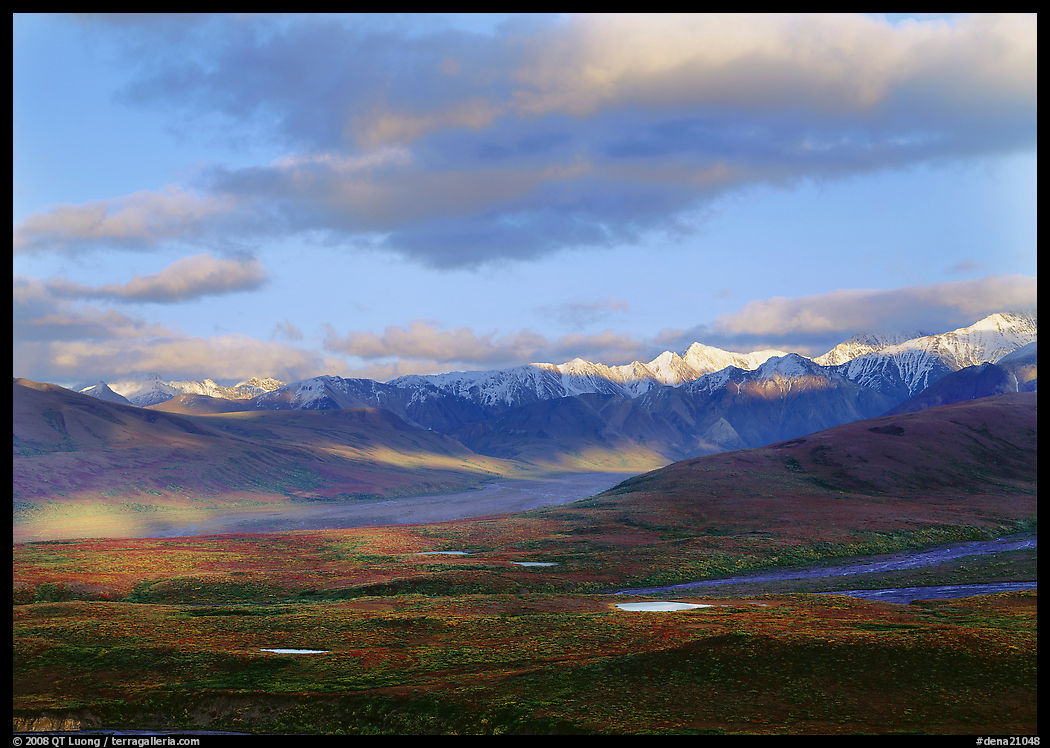 Tarn lakes, tundra, and snowy mountains of Alaska Range with patches of light. Denali  National Park, Alaska, USA.