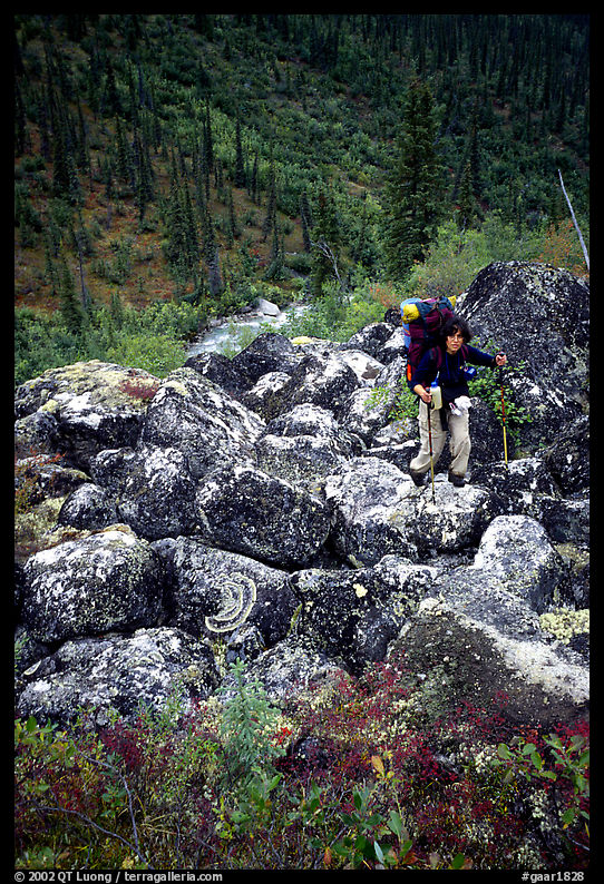 Backpacker on boulder field in Arrigetch Creek. Gates of the Arctic National Park, Alaska