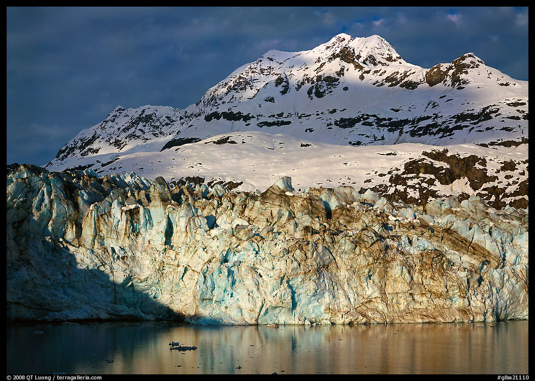 Face of Lamplugh Glacier illuminated by the sun on cloudy day. Glacier Bay National Park, Alaska, USA.