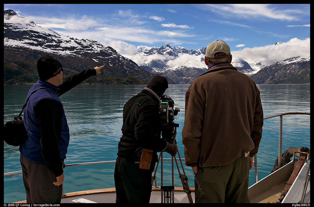 Crew filming from the deck of a boat. Glacier Bay National Park, Alaska, USA.