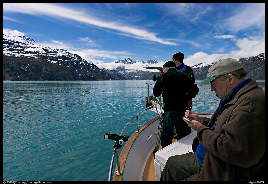 Film producer taking notes as crew films. Glacier Bay National Park, Alaska, USA.