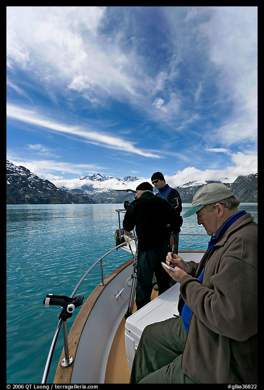 Movie producer taking notes as crew films. Glacier Bay National Park, Alaska, USA.