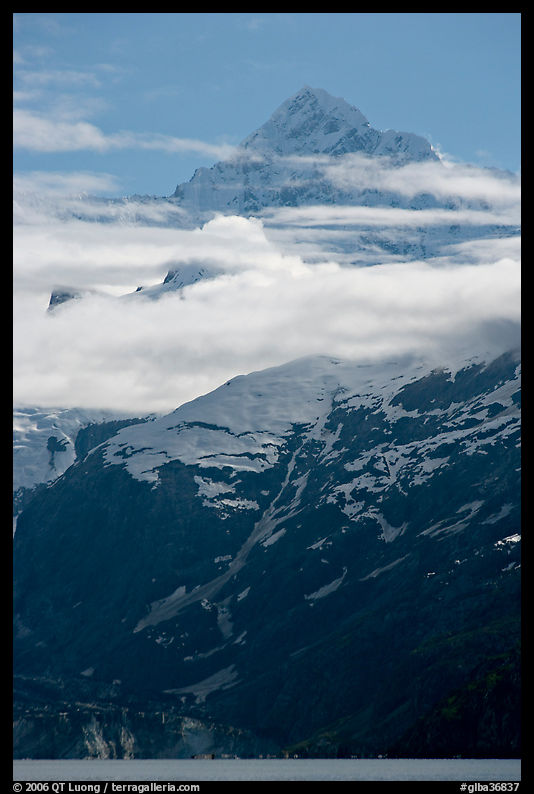 Pointed mountain with clouds hanging below. Glacier Bay National Park, Alaska, USA.