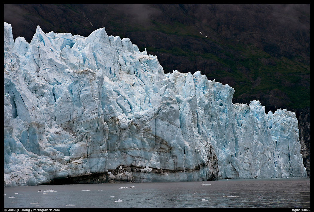 Front of Margerie Glacier against dark mountainside. Glacier Bay National Park, Alaska, USA.