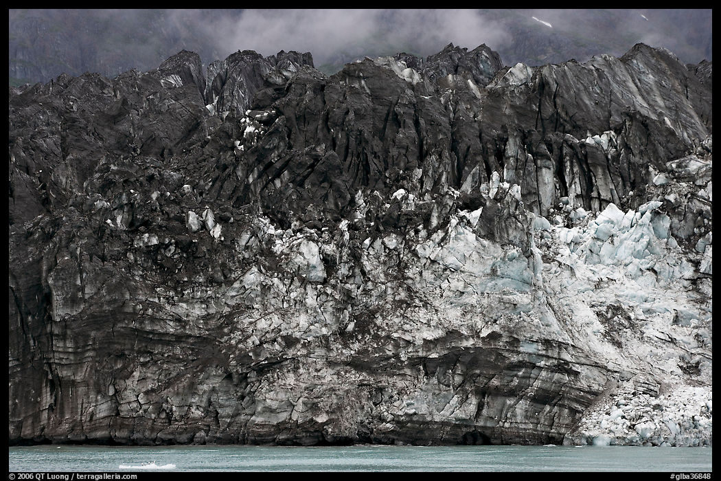 Ice colored by black moraining debris on the front of Margerie Glacier. Glacier Bay National Park, Alaska, USA.