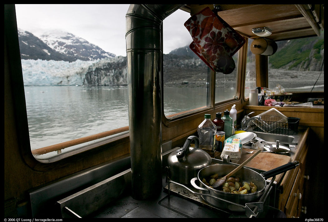 Breakfast potatoes in a small boat moored in front of glacier. Glacier Bay National Park, Alaska, USA.