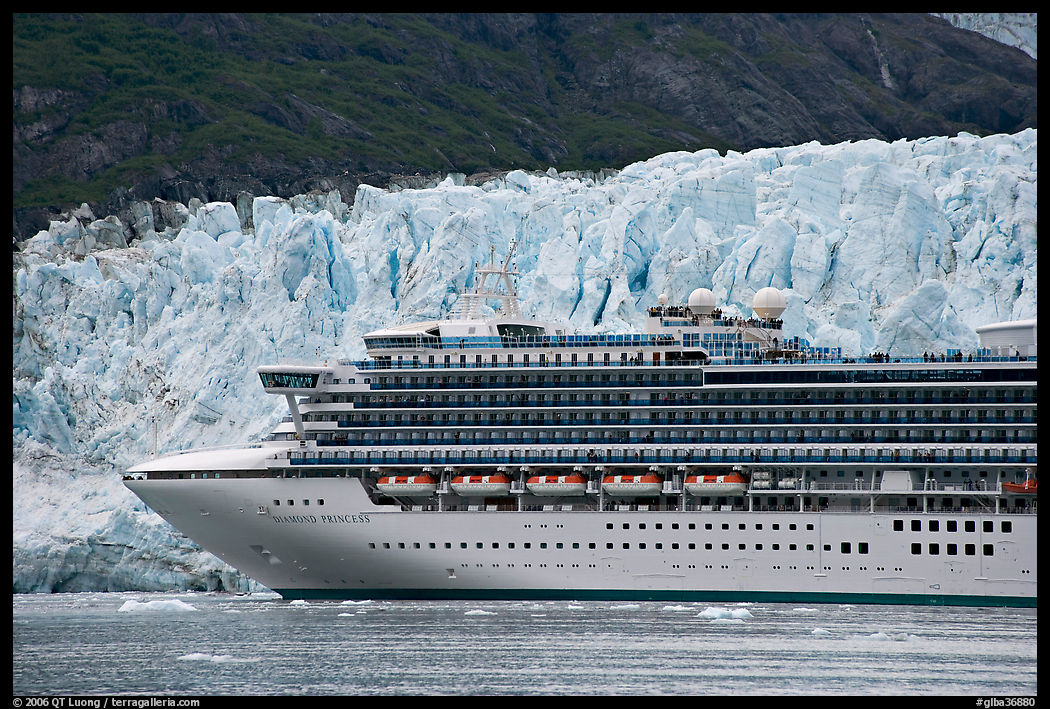 Cruise ship dwarfed by the face of Margerie Glacier. Glacier Bay National Park, Alaska, USA.