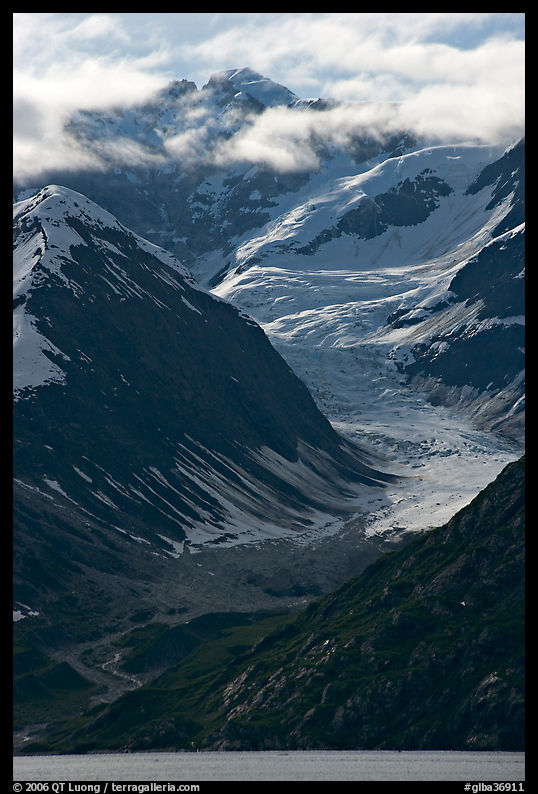 Topeka Glacier, peak and clouds, late afternoon. Glacier Bay National Park, Alaska, USA.