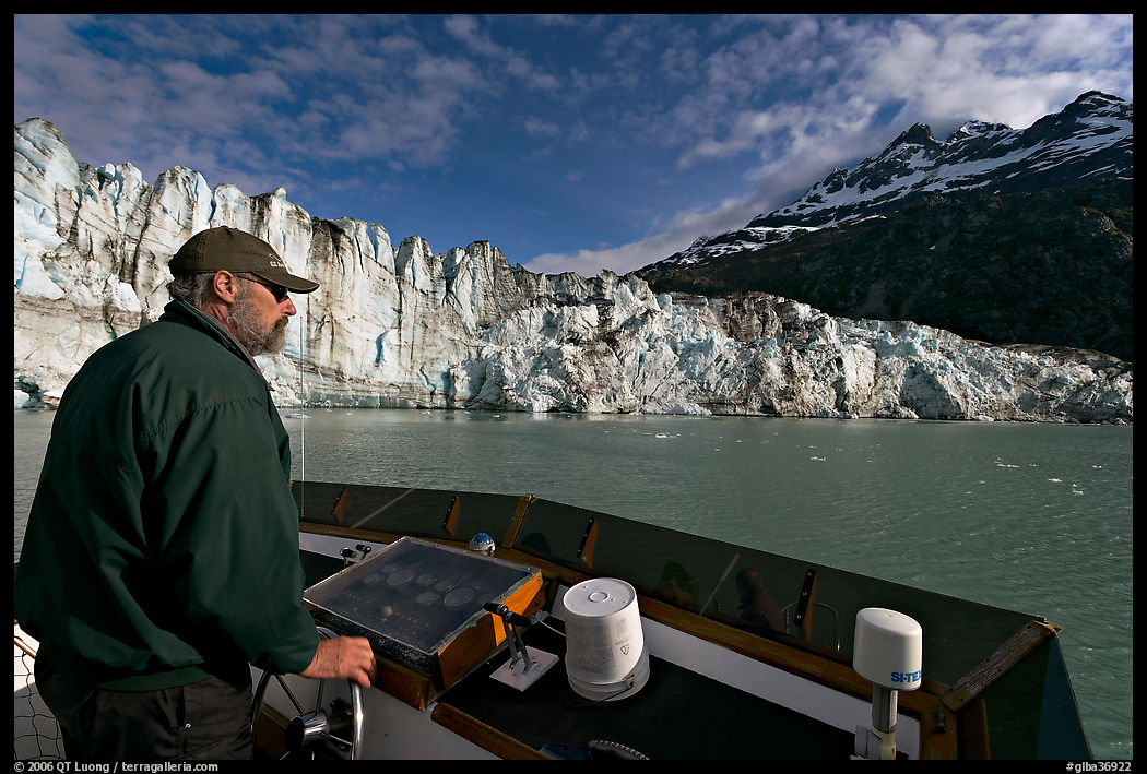 Captain guiding boat near Lamplugh glacier. Glacier Bay National Park, Alaska, USA.