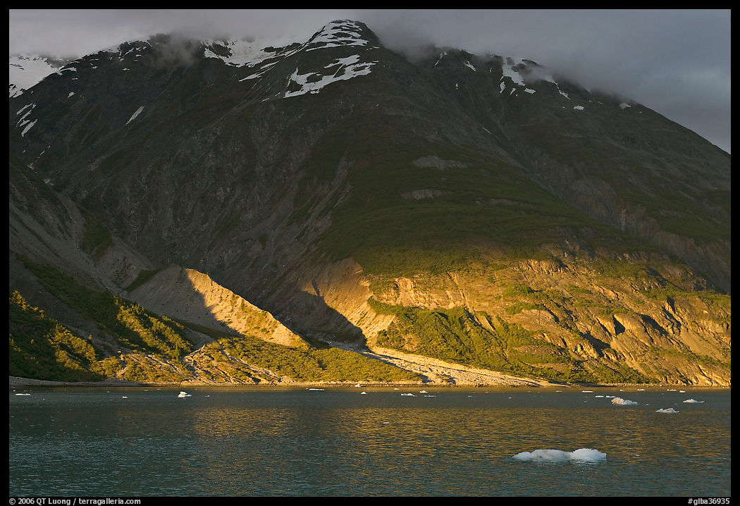 Sunset light falling on the base of the peaks around Tarr Inlet. Glacier Bay National Park, Alaska, USA.