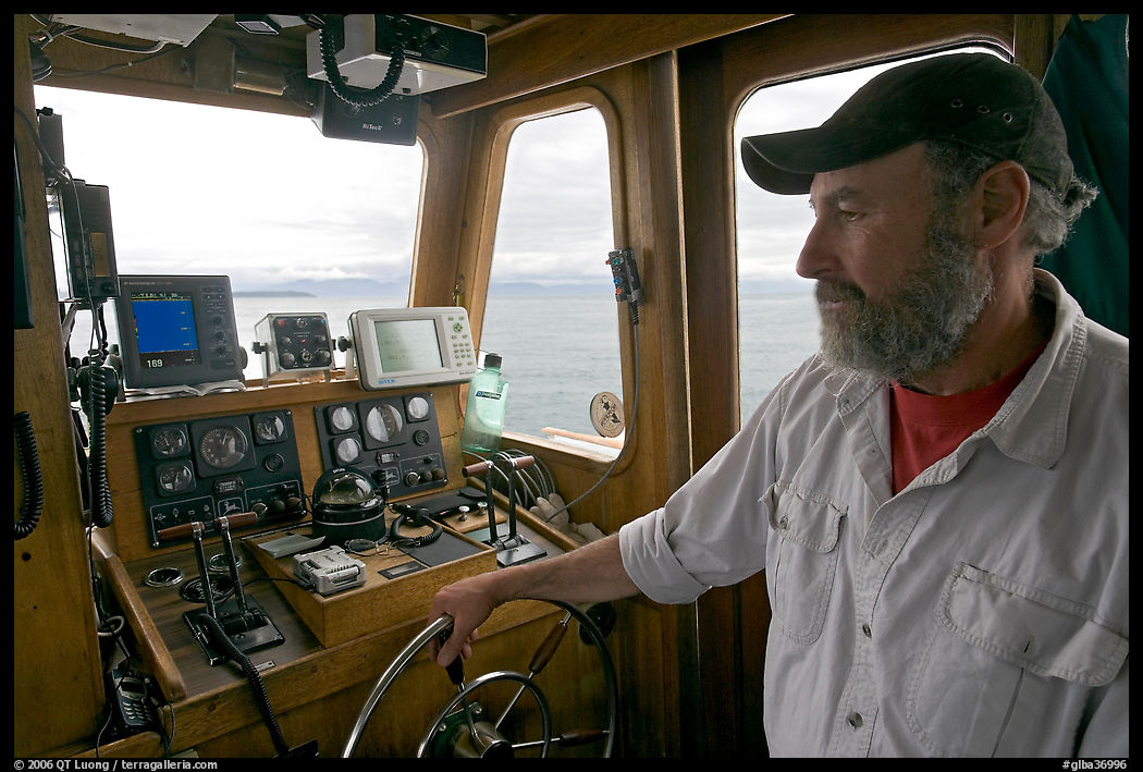 Captain steering boat with navigation instruments. Glacier Bay National Park