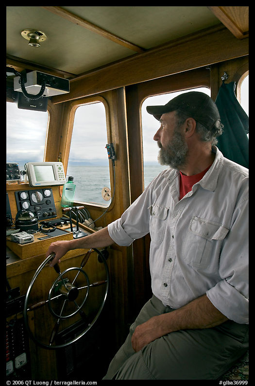 Captain steering boat using navigation instruments. Glacier Bay National Park