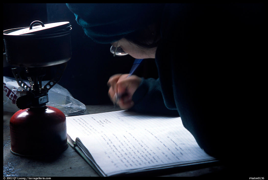 Backpacker writes into the visitor log in the USGS research cabins, Valley of Ten Thousand smokes. Katmai National Park, Alaska