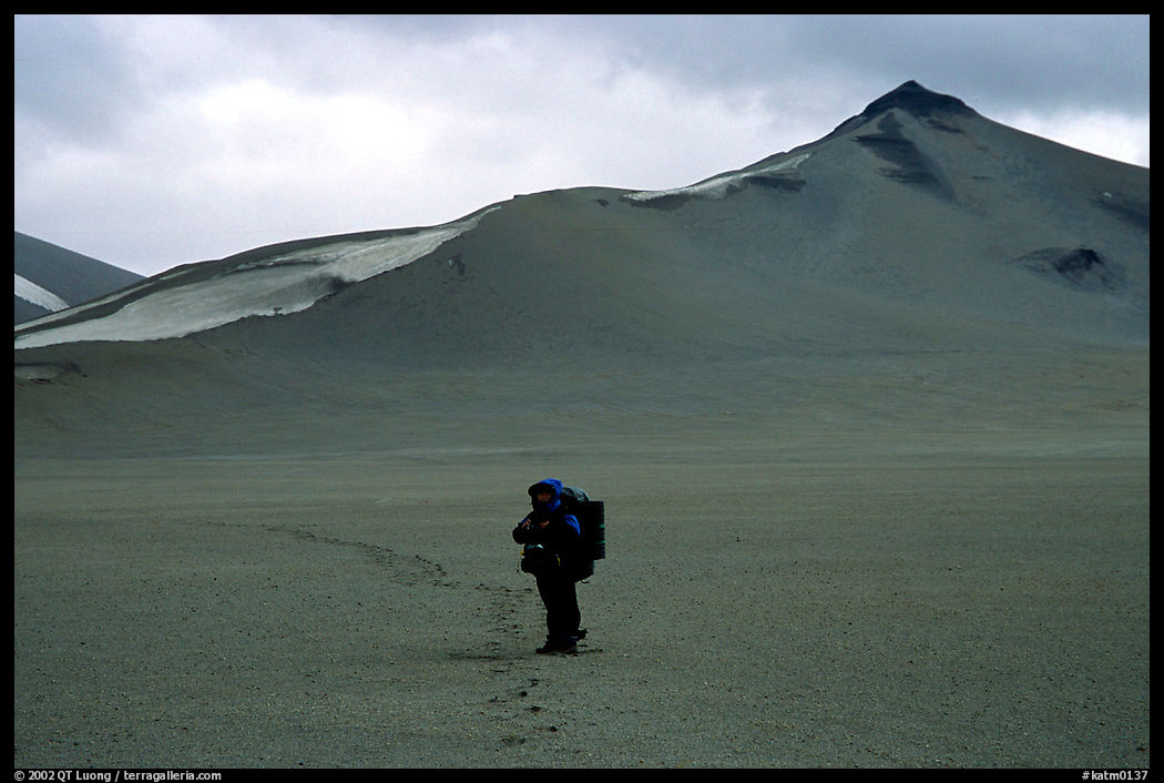 Backpacker leaves the Baked mountain behind, Valley of Ten Thousand smokes. Katmai National Park, Alaska