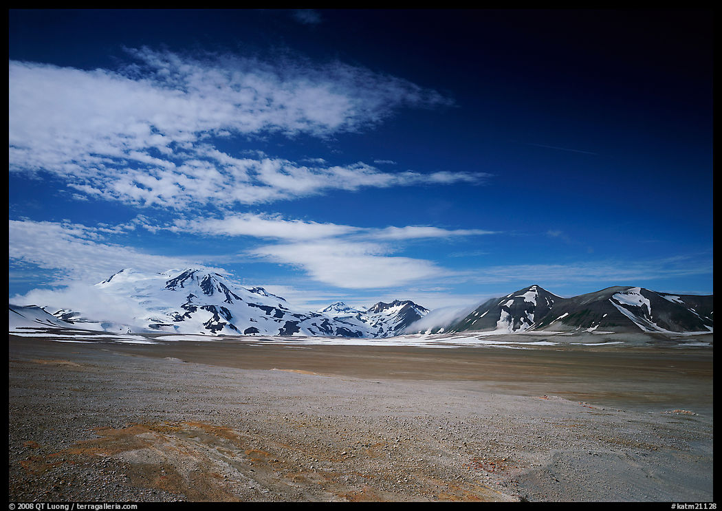 Snow-covered peaks surrounding the arid ash-covered floor of the Valley of Ten Thousand smokes. Katmai National Park, Alaska, USA.