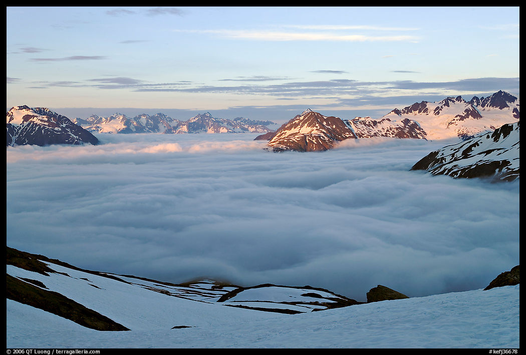 Peaks emerging from clouds at sunset. Kenai Fjords  National Park, Alaska, USA.