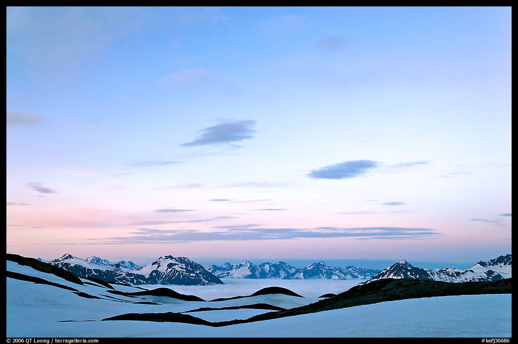 Pastel sky, mountain ranges and sea of clouds at dusk. Kenai Fjords  National Park, Alaska, USA.