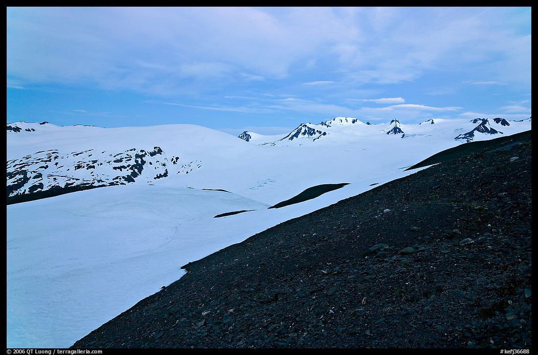 Rocky slope and snow-covered Harding Icefield at dusk. Kenai Fjords  National Park, Alaska, USA.