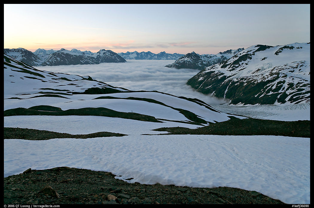 Bands freshly uncovered by snow, and low clouds, sunrise. Kenai Fjords  National Park, Alaska, USA.
