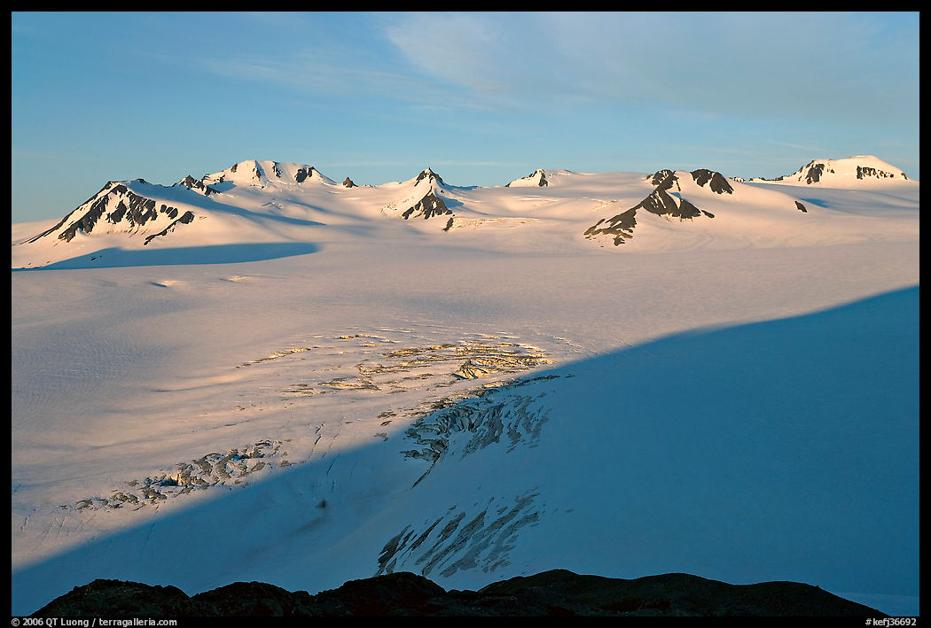 Snow-covered glacier and Harding Ice field peaks, sunrise. Kenai Fjords  National Park, Alaska, USA.