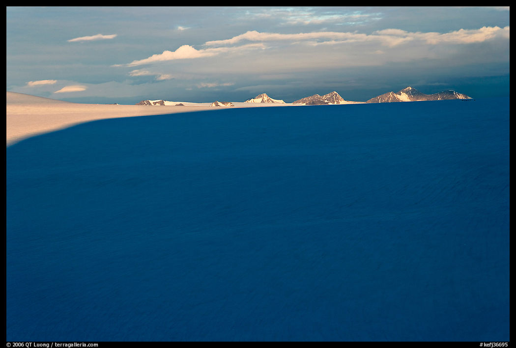 Distant mountains emerging from shadows over the Harding field. Kenai Fjords  National Park