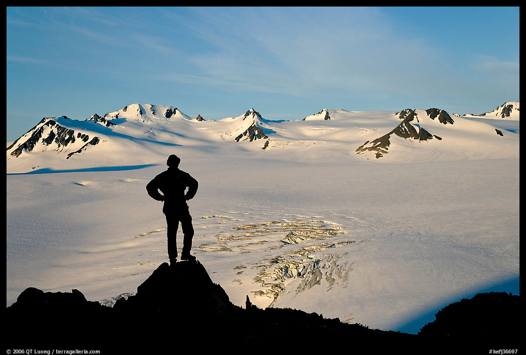 Man standing on overlook above Harding ice field, early morning. Kenai Fjords  National Park, Alaska, USA.