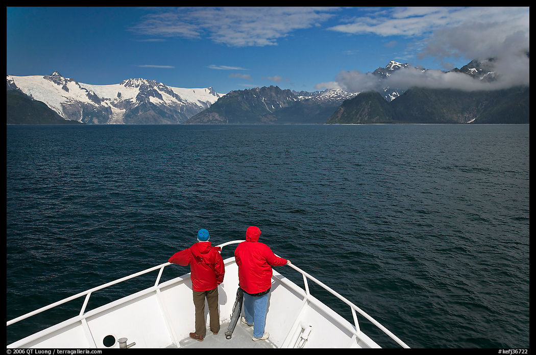 Passengers with red jackets on bow of tour boat, Northwestern Fjord. Kenai Fjords  National Park, Alaska, USA.