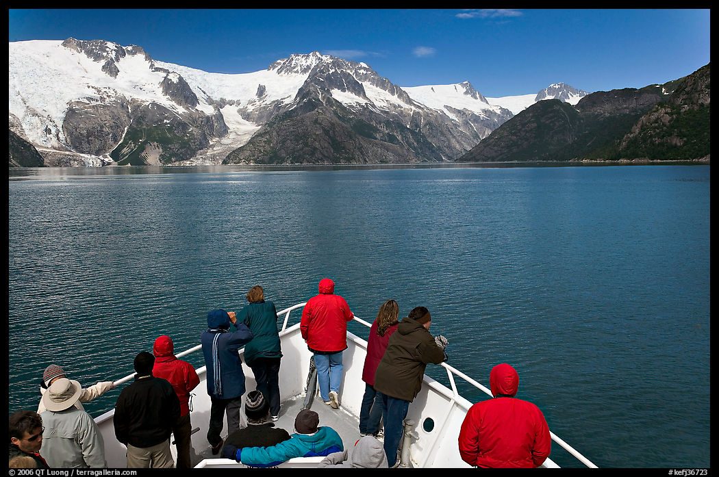 Vistors on bow of tour boat approaching glacier, Northwestern Fjord. Kenai Fjords  National Park, Alaska, USA.