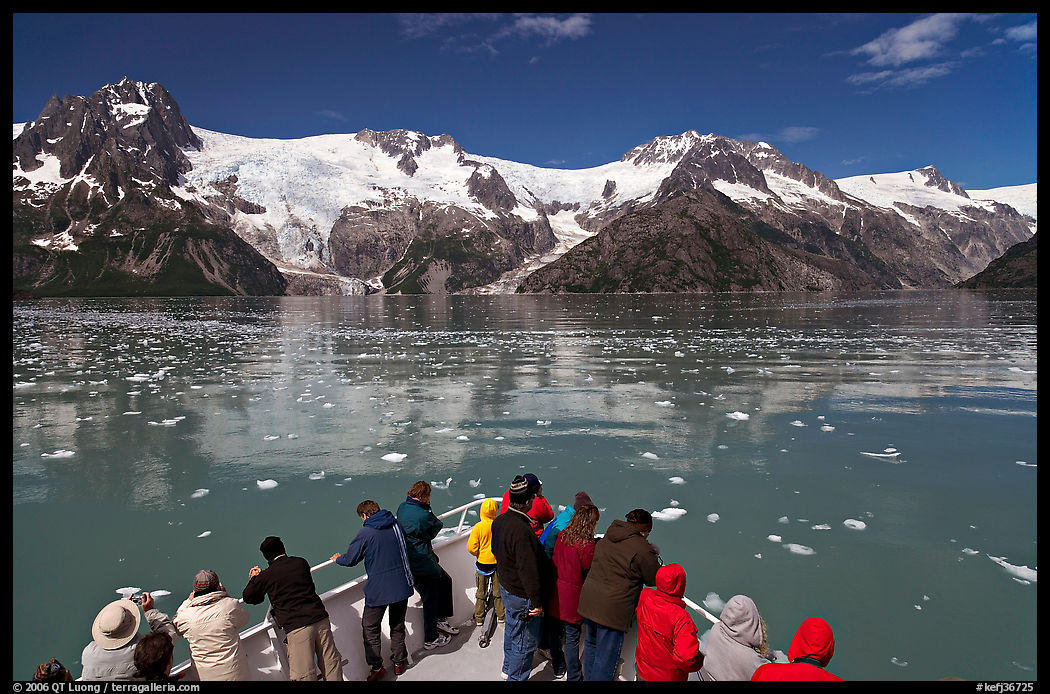 People looking at glaciers as boat crosses ice-chocked waters, Northwestern Fjord. Kenai Fjords  National Park, Alaska, USA.