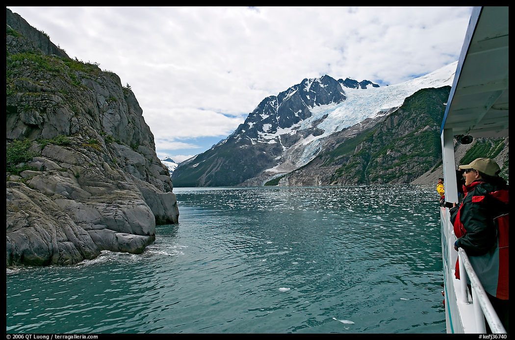 Passenger on small tour boat, island and glacier, Northwestern Fjord. Kenai Fjords  National Park, Alaska, USA.