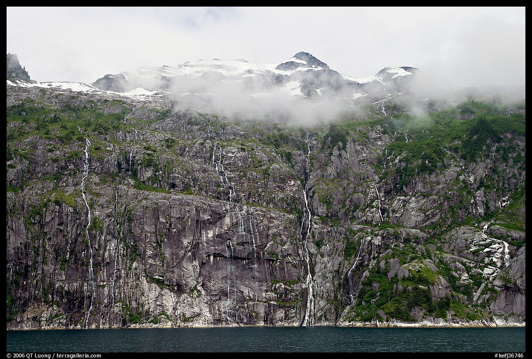 Wall of waterfalls streaming into Cataract Cove, Northwestern Fjord. Kenai Fjords  National Park, Alaska, USA.