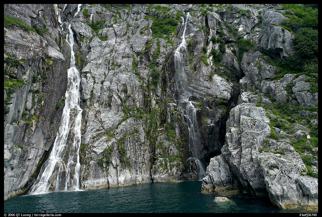 Waterfalls streaming into the ocean, Cataract Cove, Northwestern Fjord. Kenai Fjords  National Park, Alaska, USA.