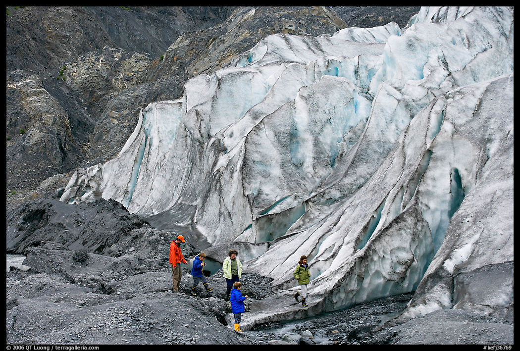 Family hiking on moraine at the base of Exit Glacier. Kenai Fjords  National Park, Alaska, USA.