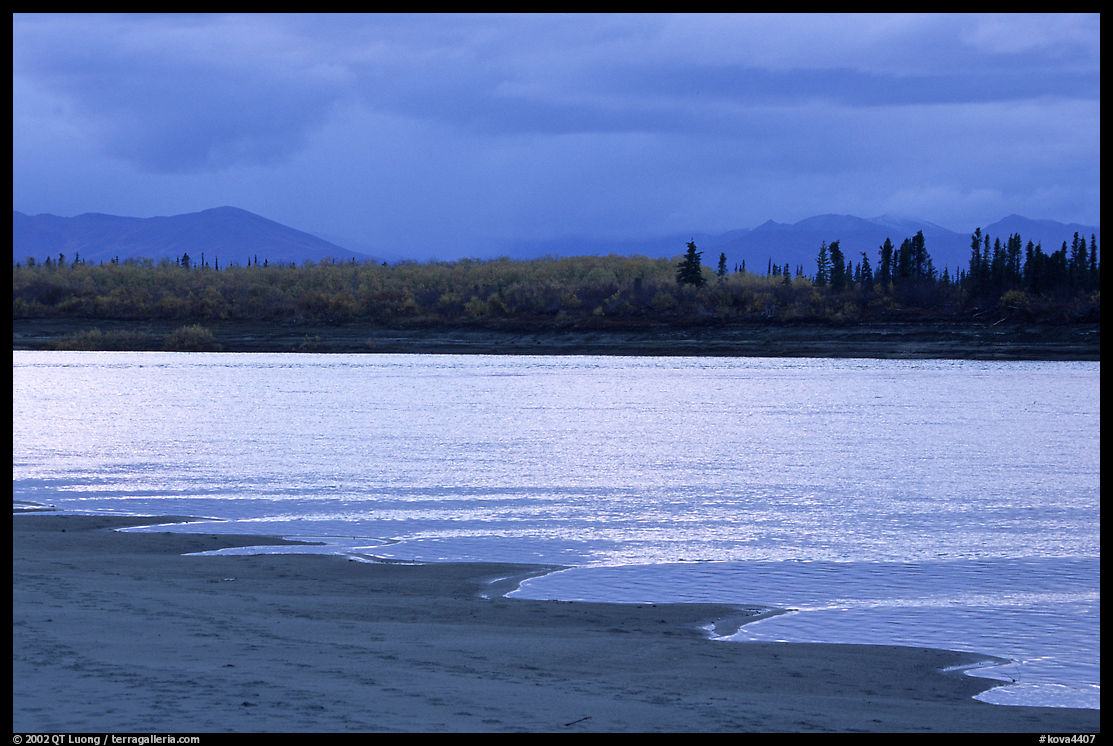 Sand bar shore, bright river and Baird mountains, evening. Kobuk Valley National Park, Alaska, USA.