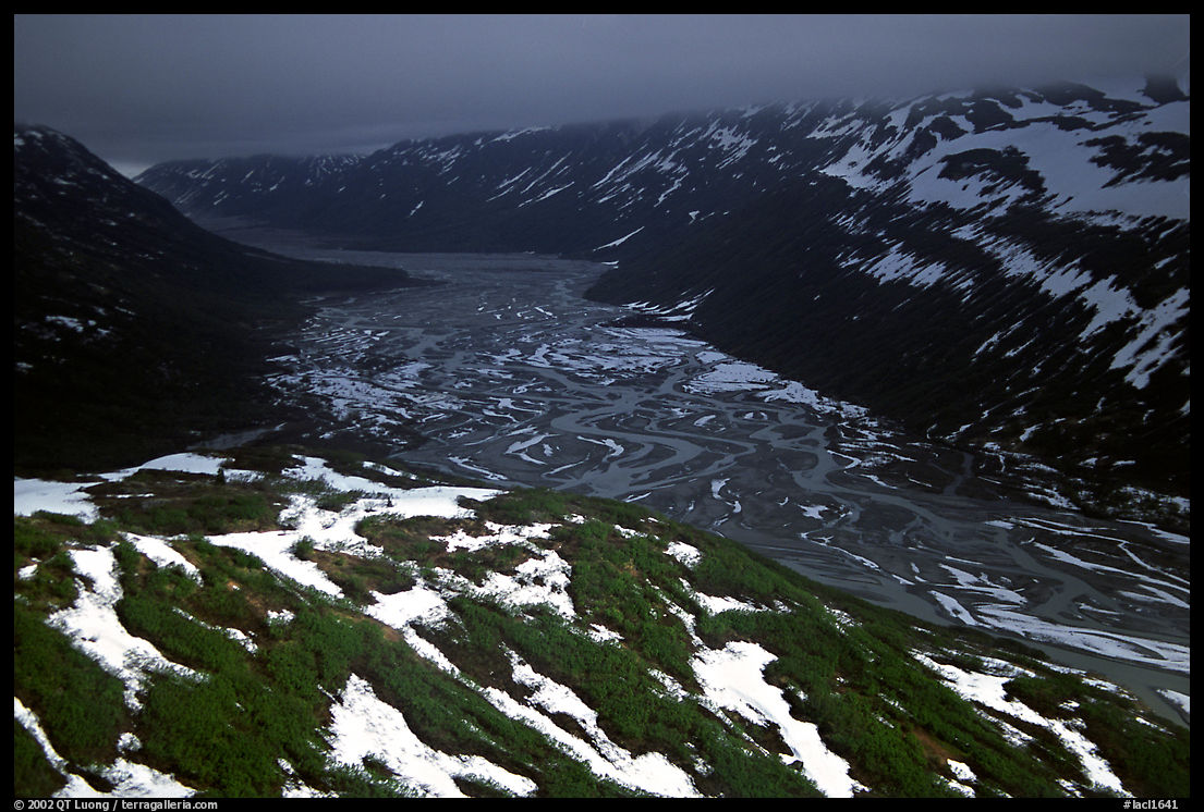 Aerial view of Tikakila River valley under dark clouds. Lake Clark National Park, Alaska, USA.