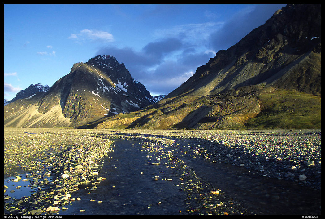 Wide gravel river bar below the Telaquana Mountains, sunset. Lake Clark National Park, Alaska, USA.