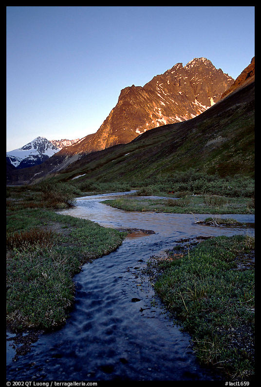 Stream on plain  below the Telaquana Mountains, late afternoon. Lake Clark National Park, Alaska, USA.