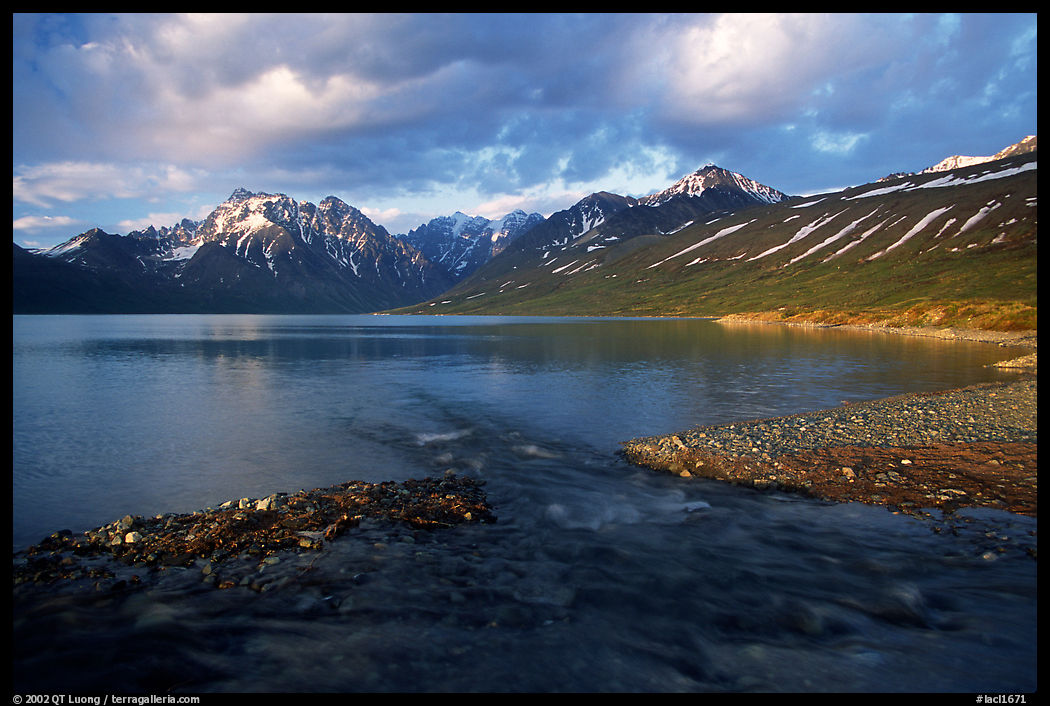 Stream flowing into Turquoise Lake, sunset. Lake Clark National Park, Alaska, USA.